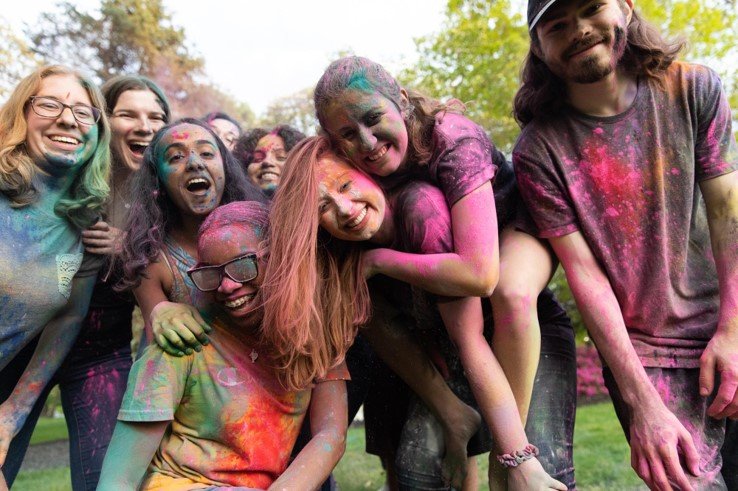 A group of students covered in puff paint.