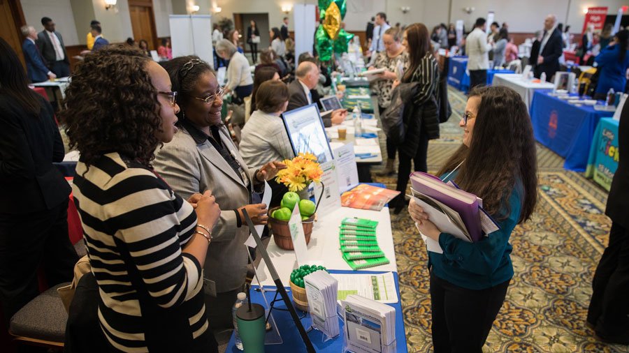 Student speaks with potential employers at a career fair