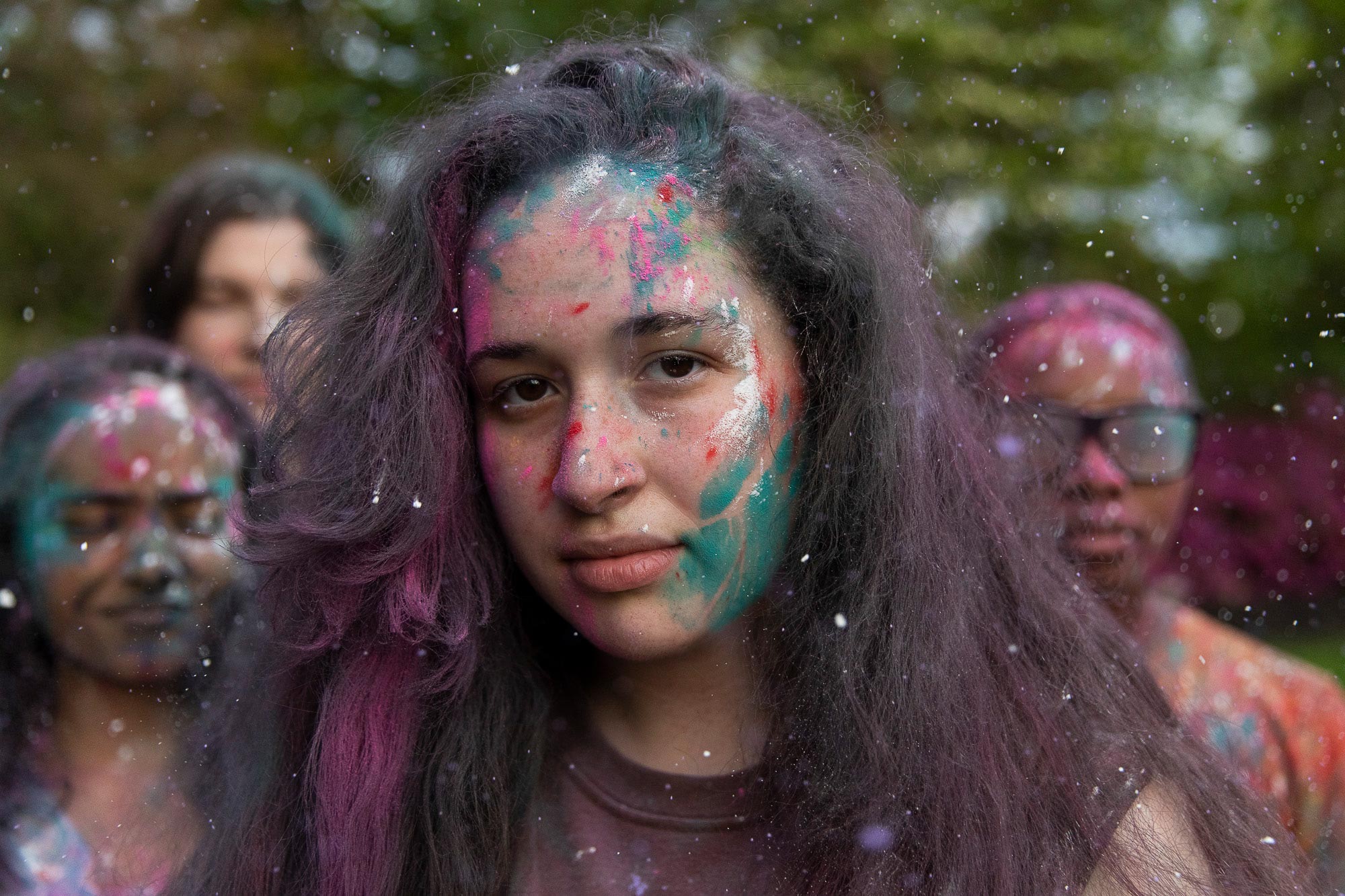 A close up portrait of a female with paint on her face