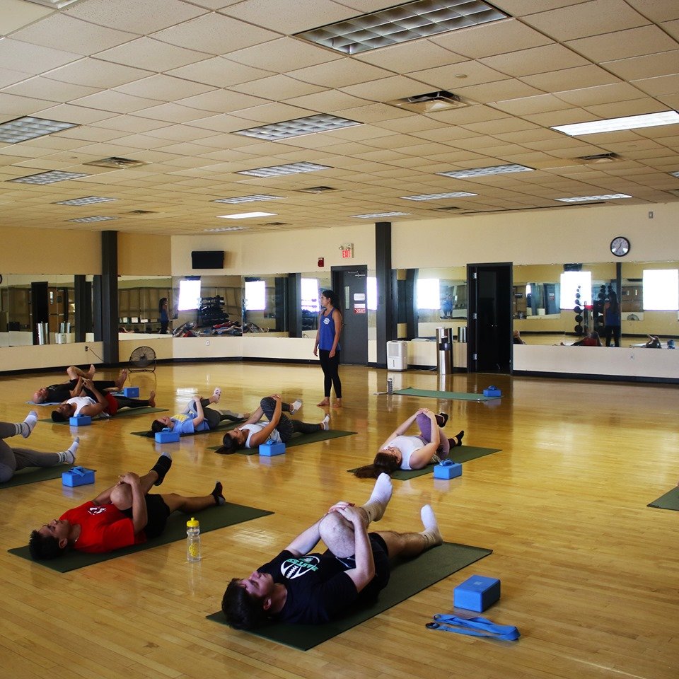 A group of students doing yoga in the Rec Center.
