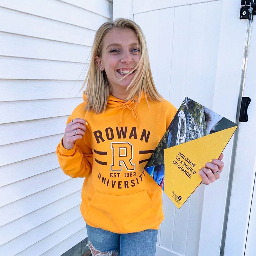 girl holding acceptance package