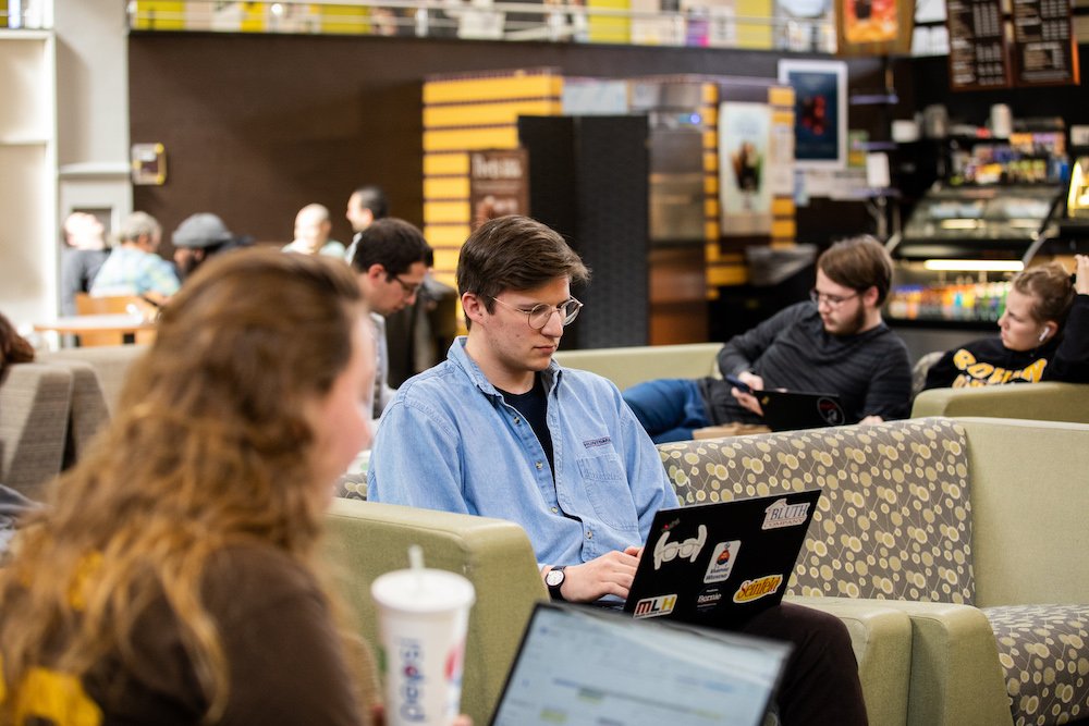 Student works on laptop in student center.