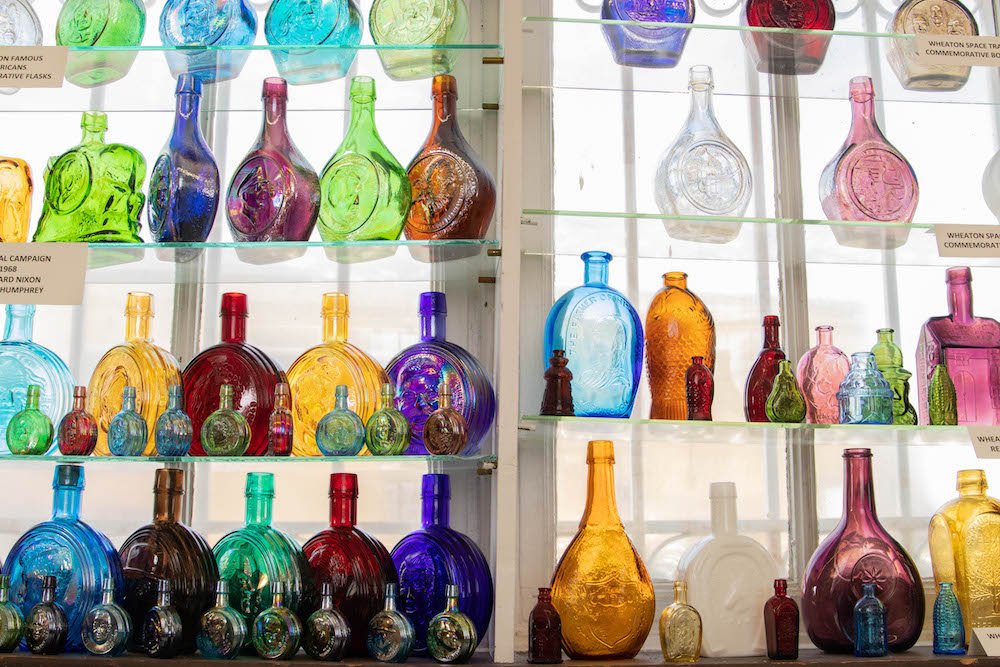 rows of colorful decorative glass vases on display