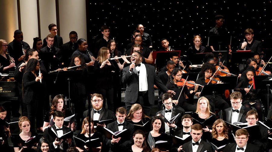 Rowan choir and orchestra, with student singing in the center of photo