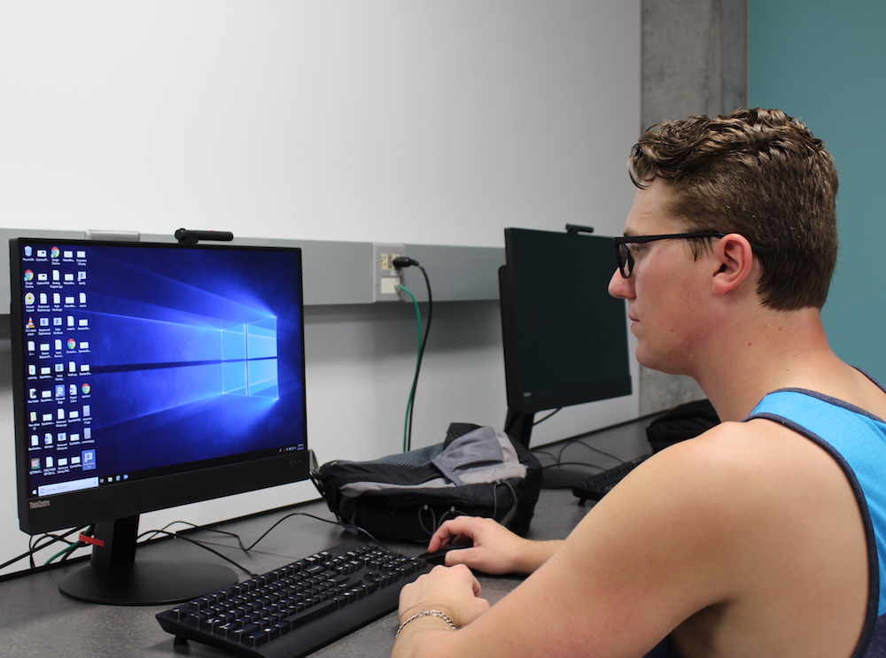 A student working on a windows desktop computer.