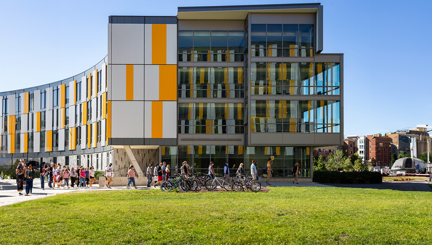 Four students hanging out together outside Wilson Hall.