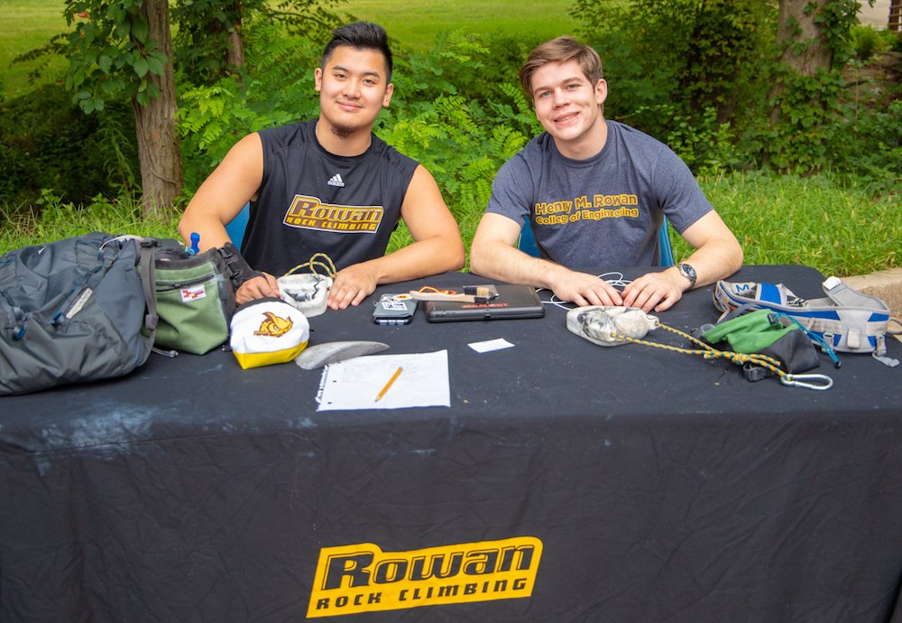 Two students sitting at the rock climbing club table