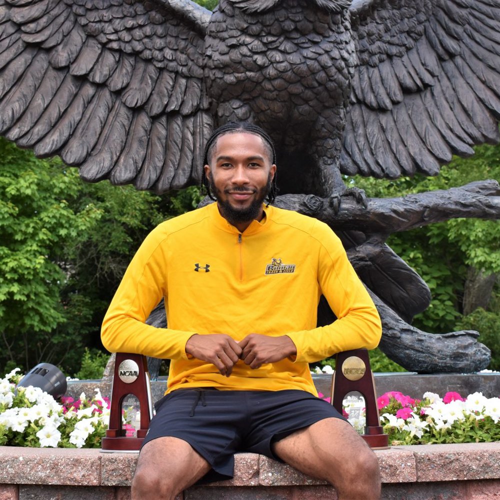 Jah’mere sits in front of the owl statue with his trophies/