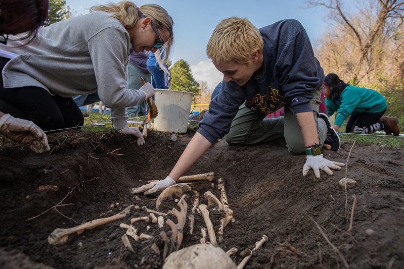 Two students at a mock dig site for a Rowan University anthropology class.