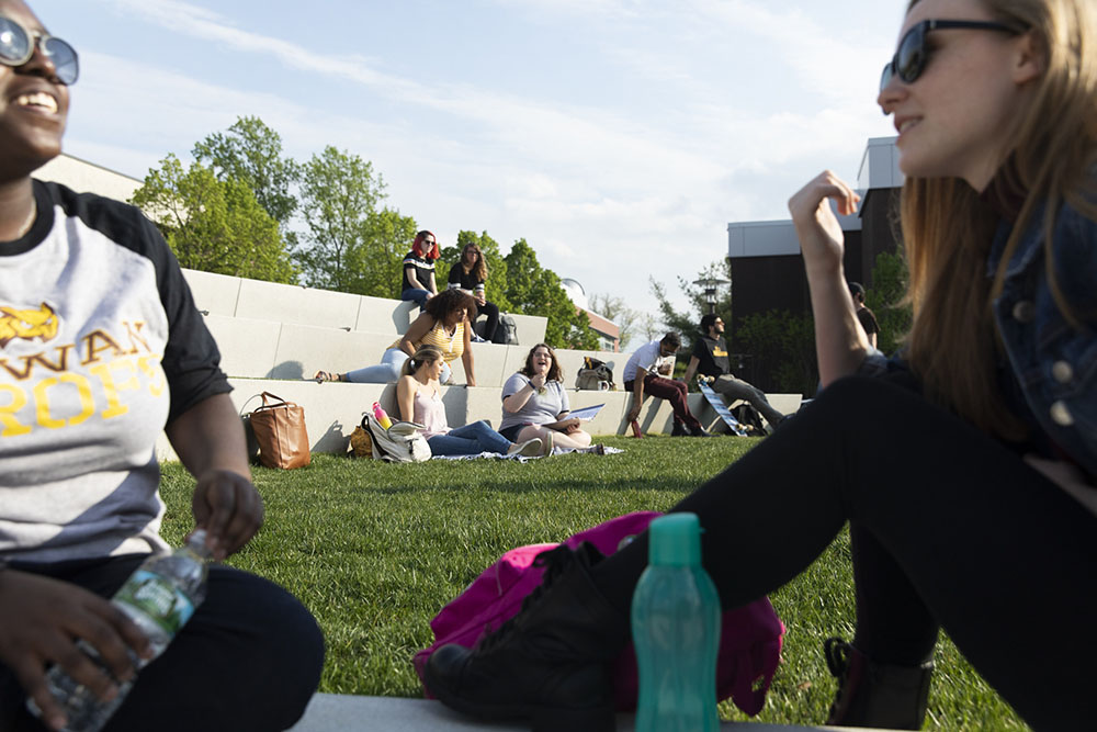 college students interacting in the outdoor theatre.