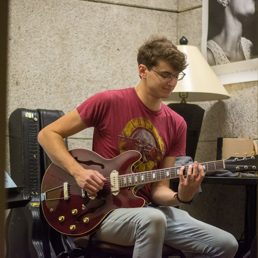 Music composition major Zachary plays his guitar