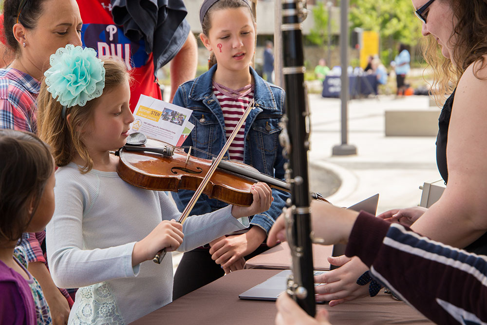A young student playing a violin