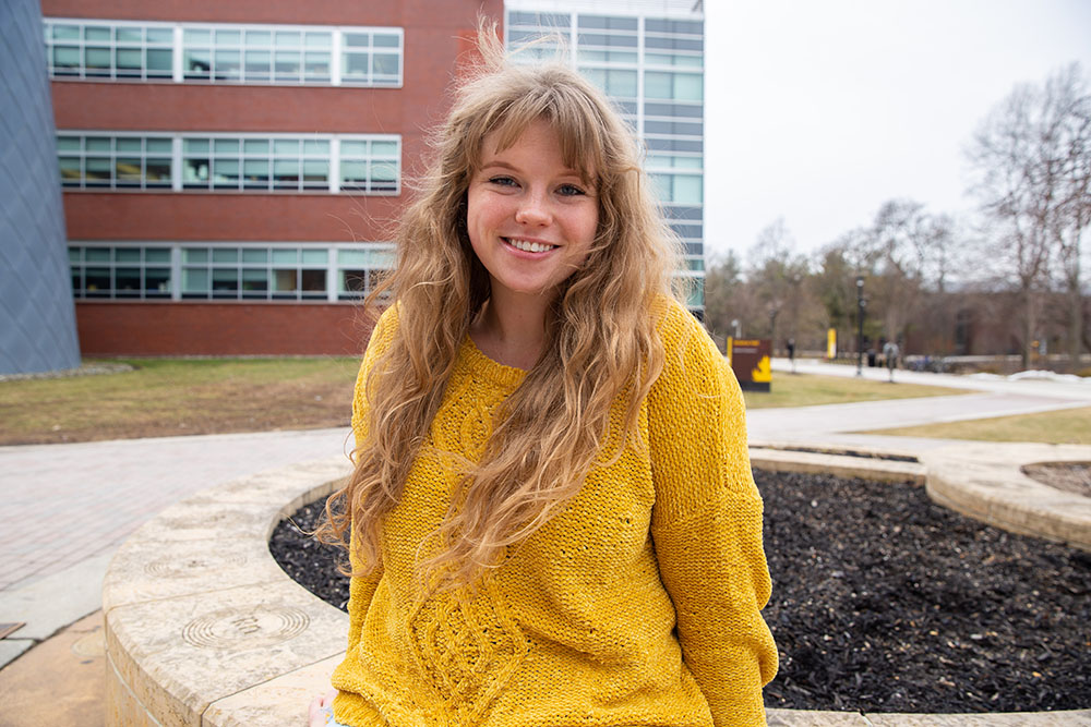 Kayla smiling outside of the science building.