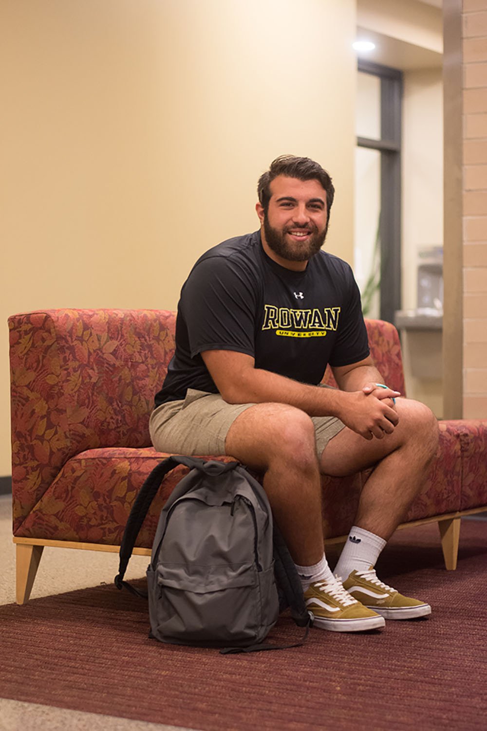 Vito sitting in student lounge on campus.