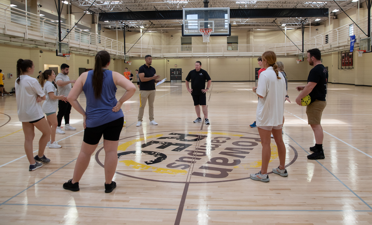 Students in a class set up with two gym professors.