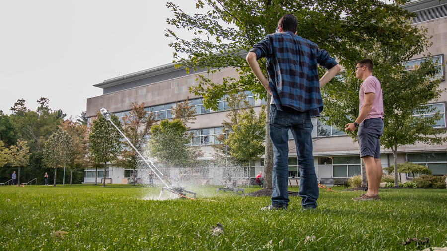 Students conduct an experiment outside Rowan Hall