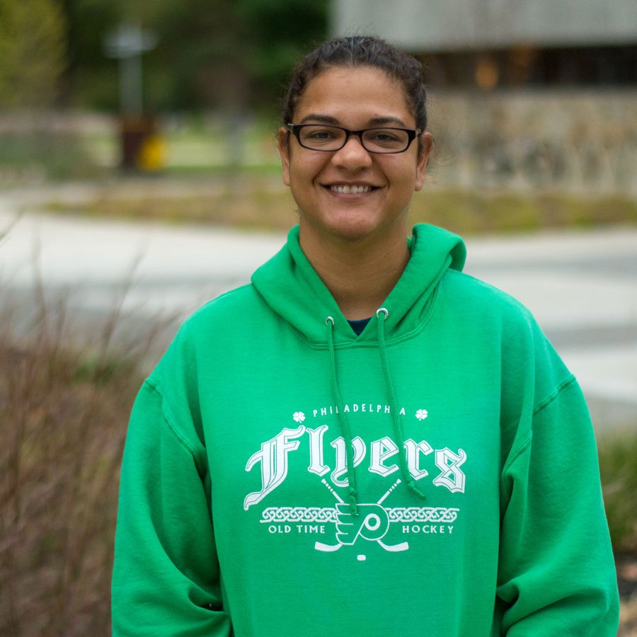 GIS major Kristina wears a green sweatshirt