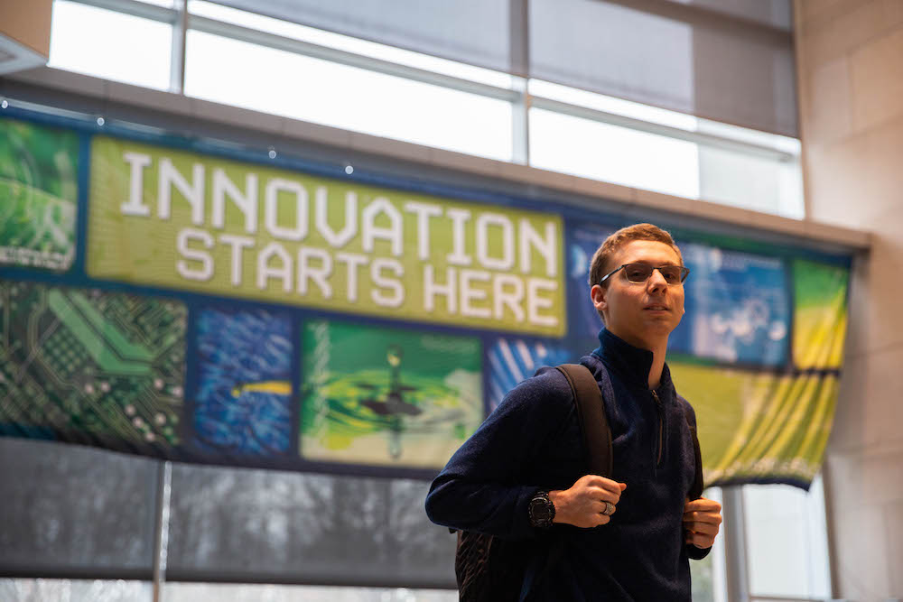 Dylan stands inside Rowan Hall.