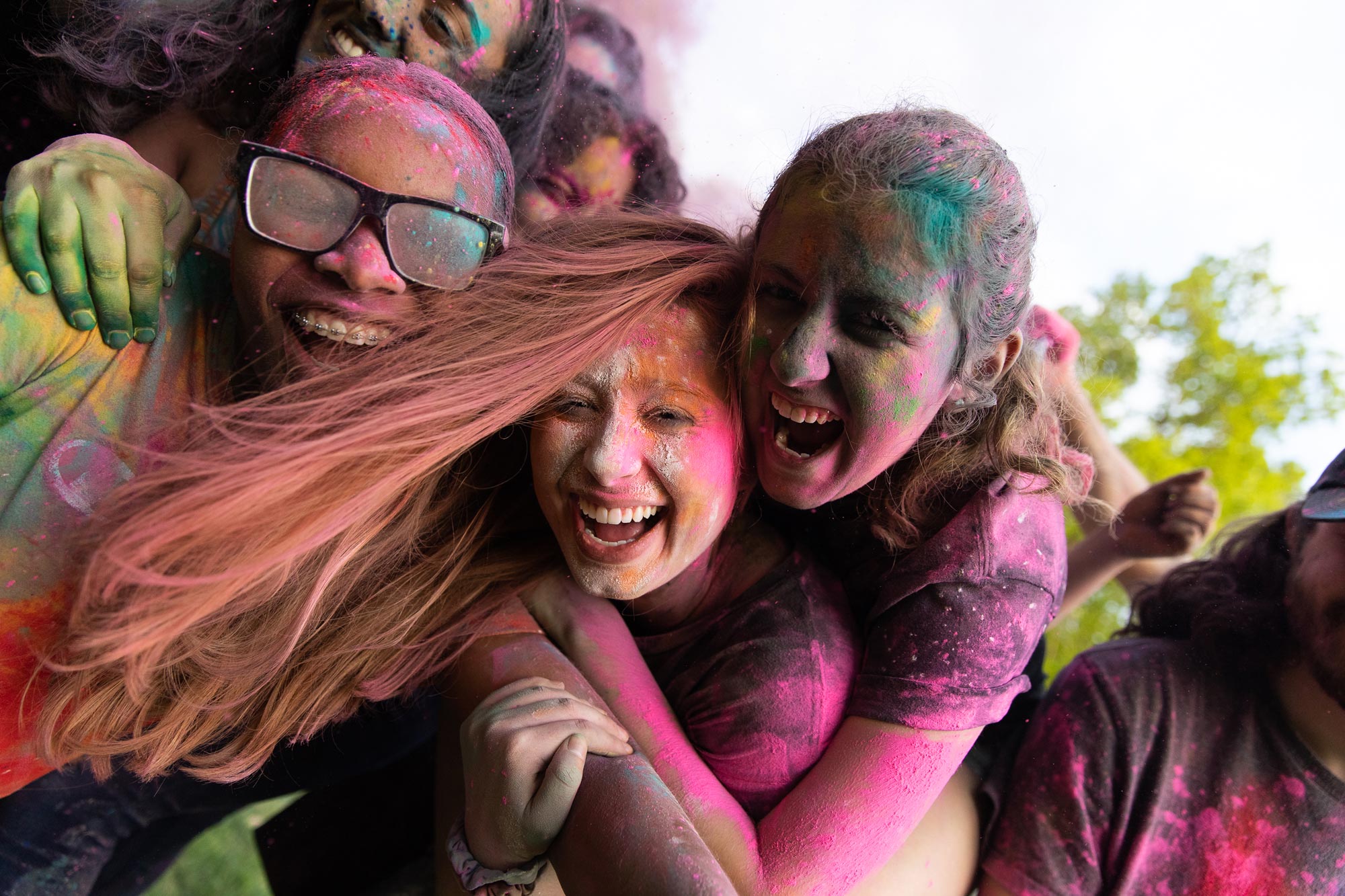 Two female students covered in puff paint smiling