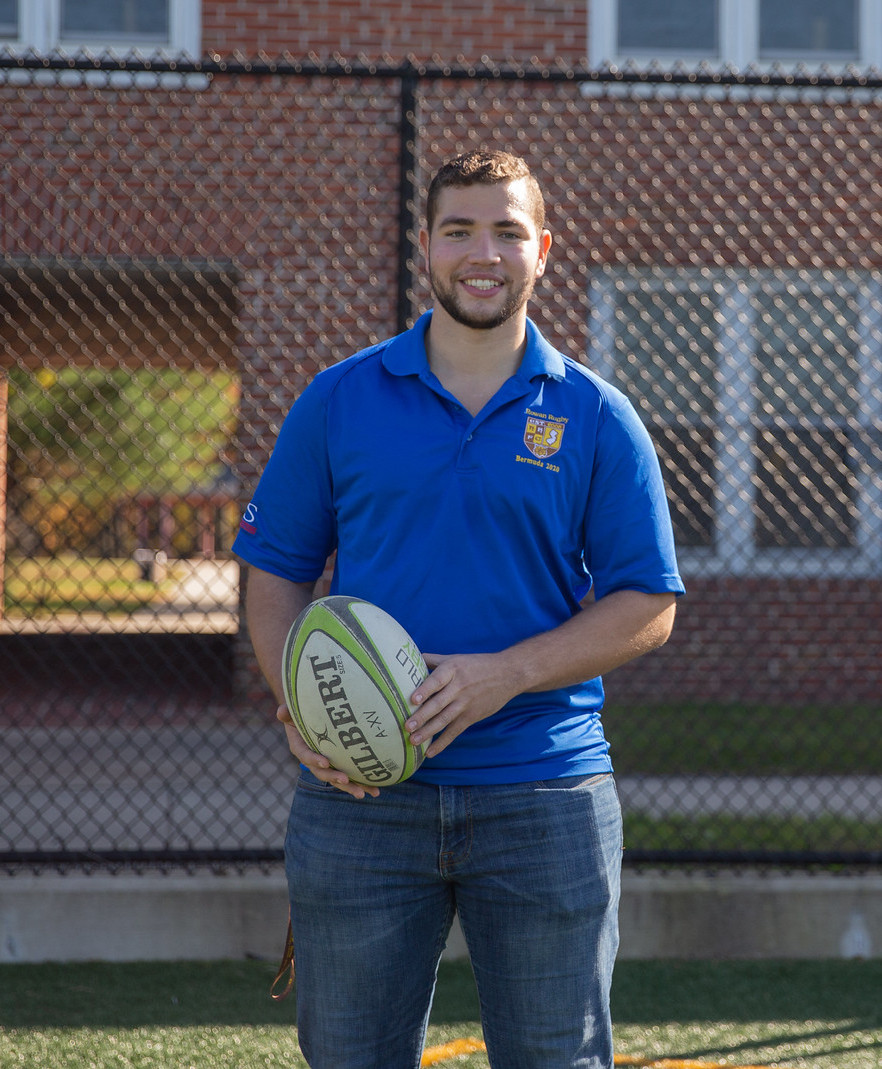 Chase holding a rugby ball.