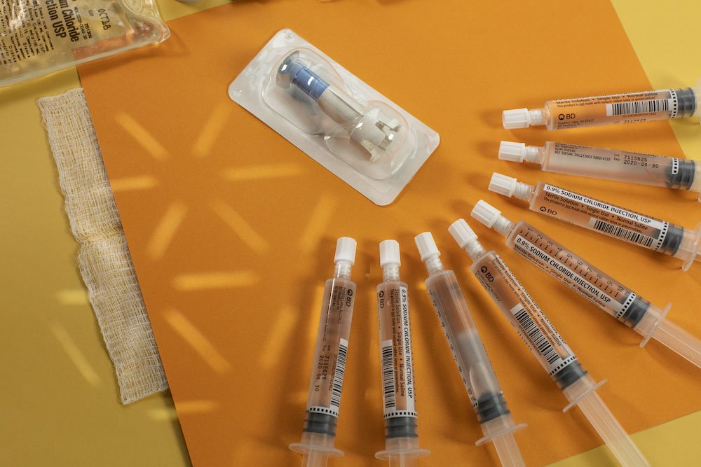 A handful of primed syringes in a Rowan University nursing rn to bsn stock photo.